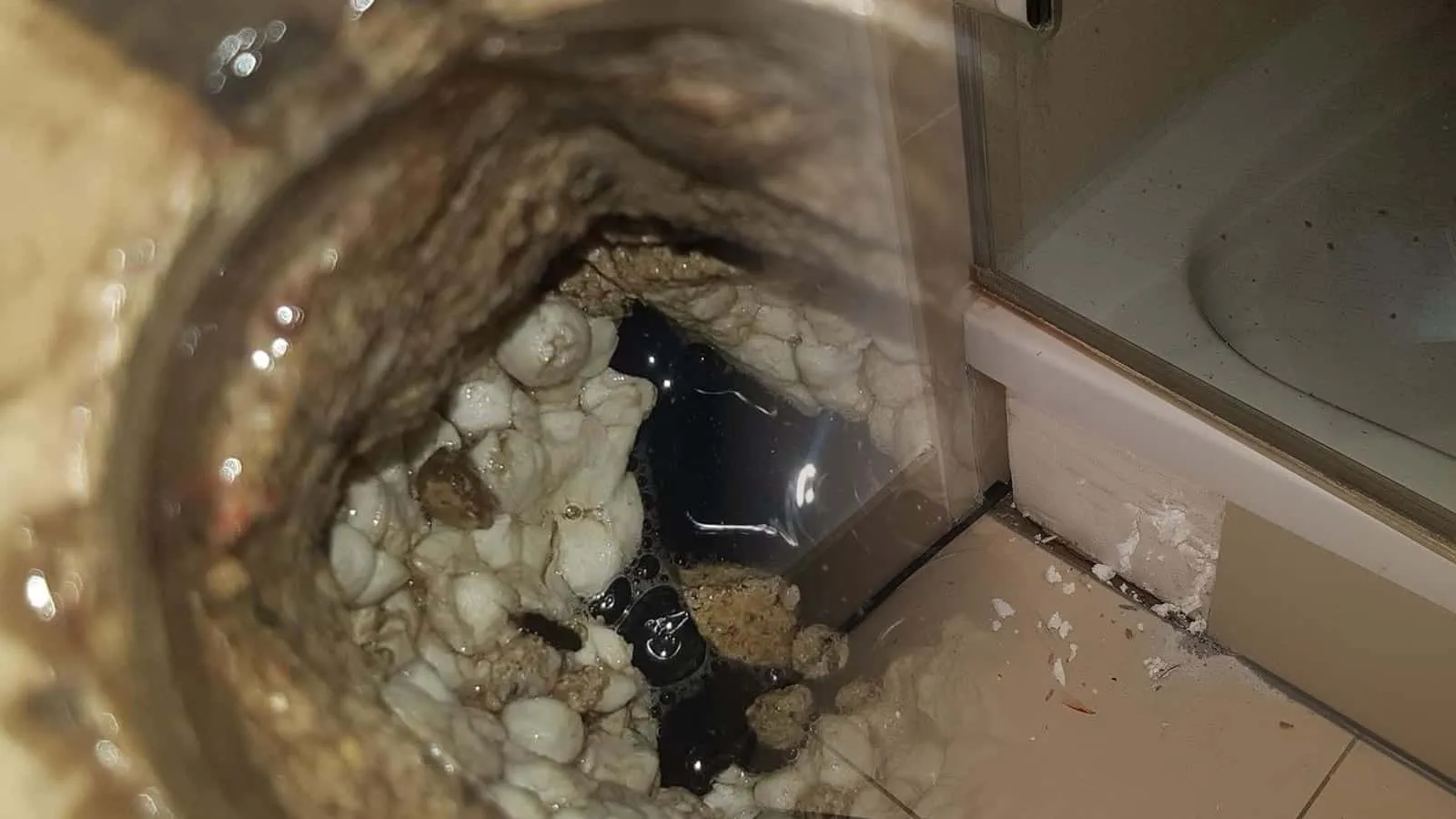 Wannenecke mit Glaswand über dem Fliesenboden
