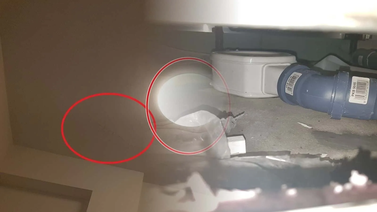 Hohlraum unter einer Badewanne mit Abflussrohr und Wannenablauf