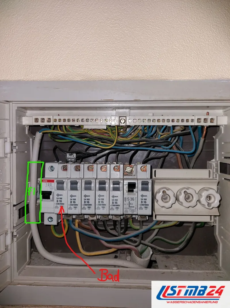 Elektriker in Grömitz: Sicherungskasten mit Fehlerstromschutzschalter und Automaten B16, ein roter Pfeil markiert den Kreis fürs Bad